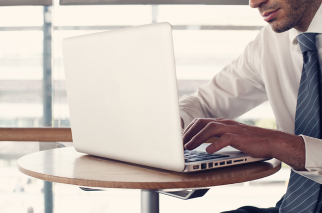 Photo of person completing application form on laptop