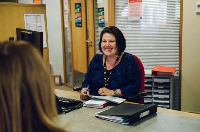 Woman sat by desk