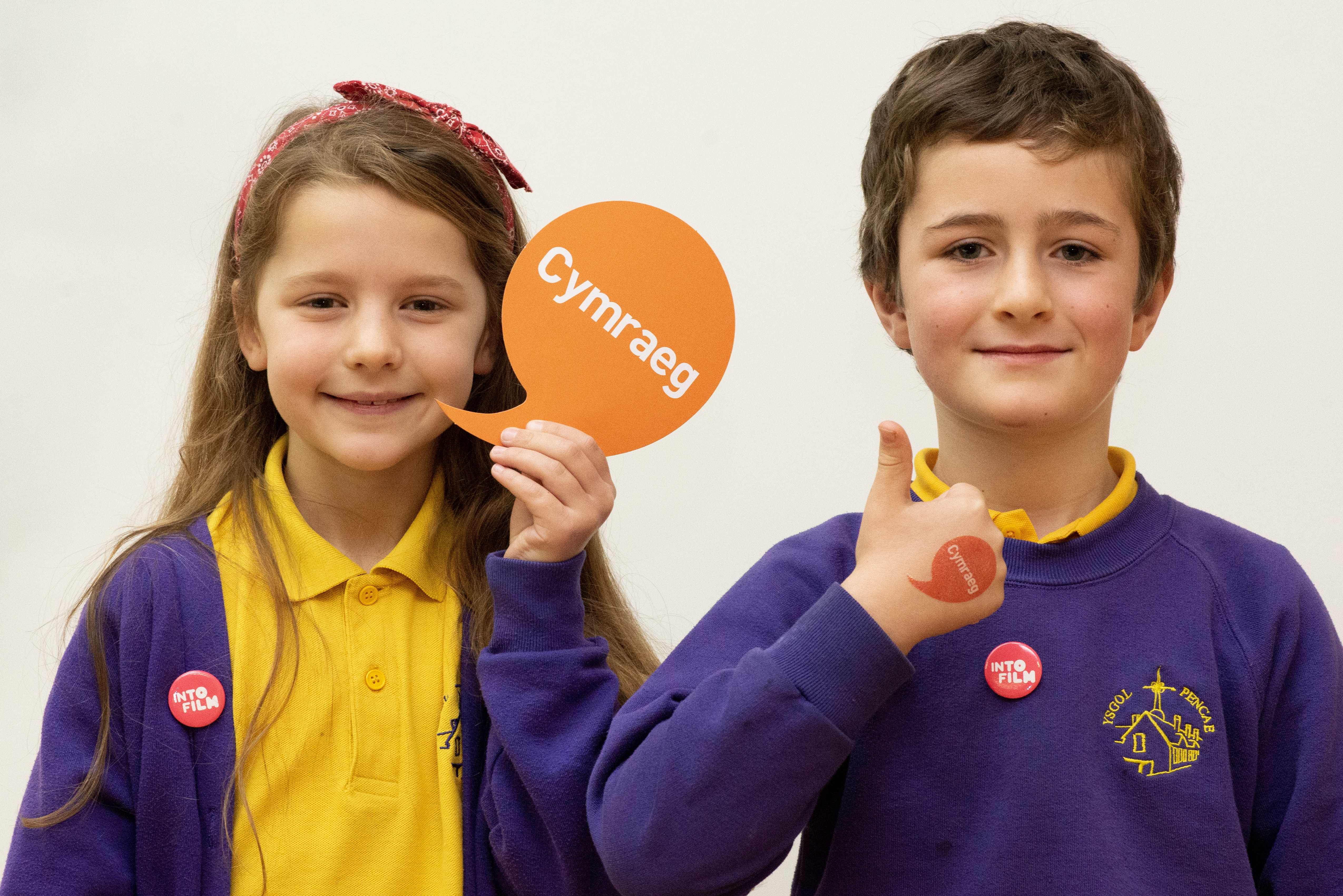 Photo of children with iaith gwaith logo