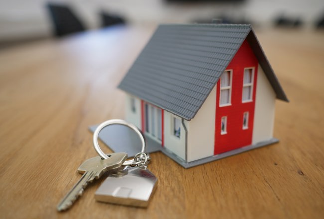 House model and house keys on a table