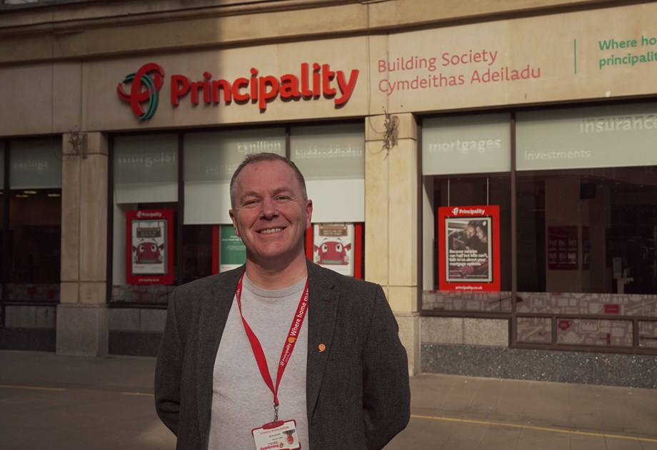 Principality staff member standing outside their building