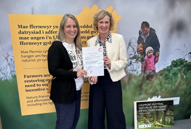 Welsh Language Commissioner presenting the Cynnig Cymraeg certificate to the WWF