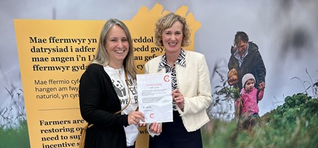 Welsh Language Commissioner presenting the Cynnig Cymraeg certificate to the WWF 