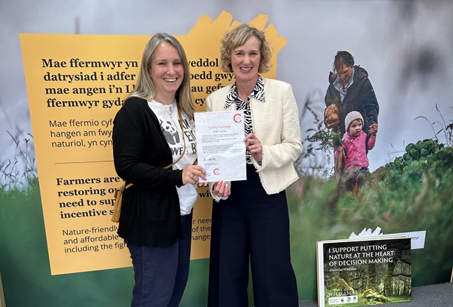 Welsh Language Commissioner presenting the Cynnig Cymraeg certificate to the WWF