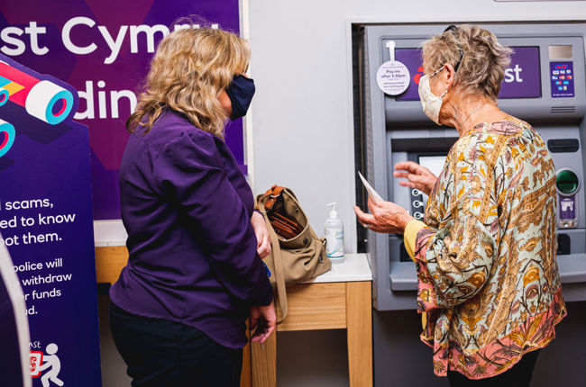 Woman helping customer in bank