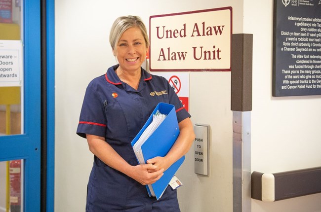 Nurse holding blue folder